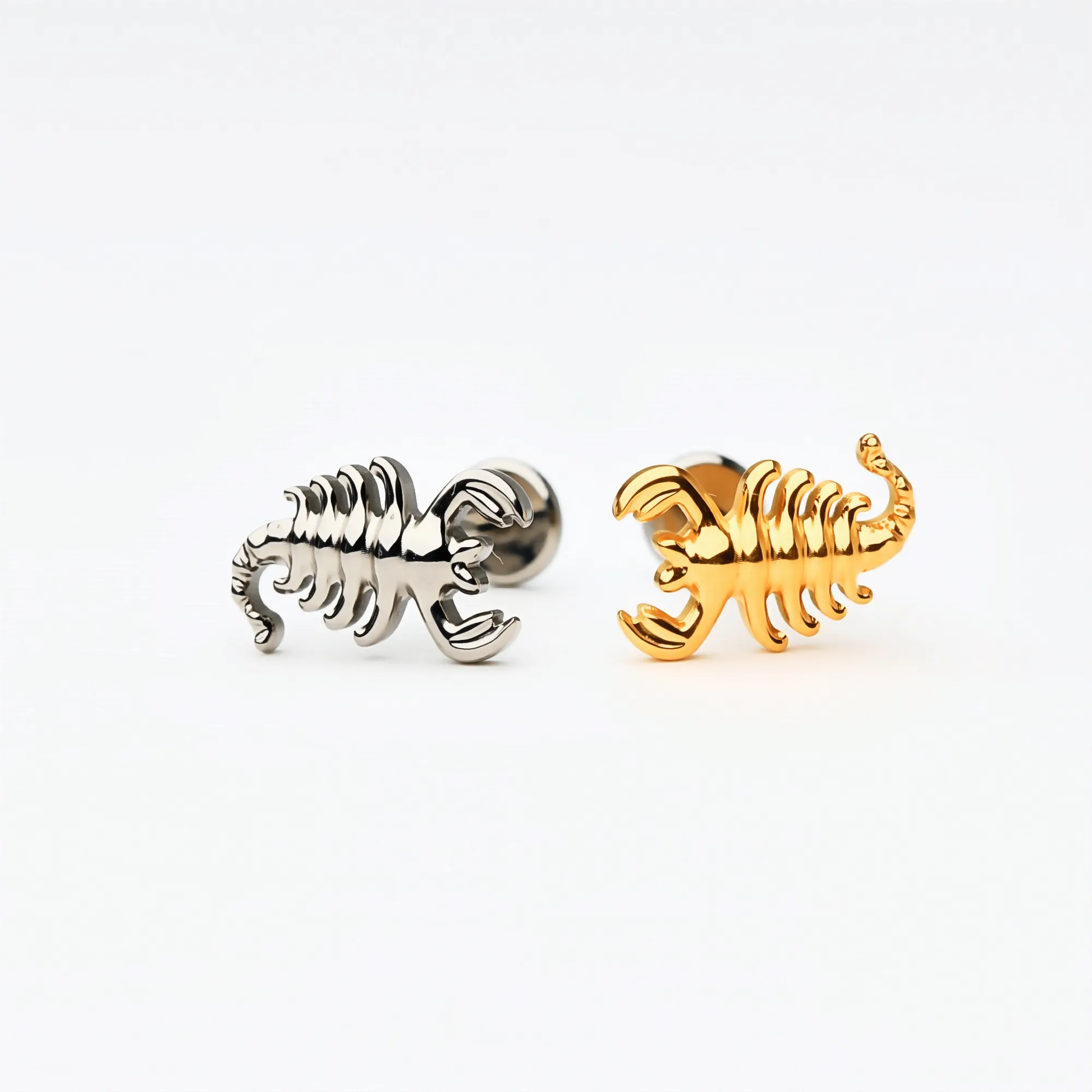 Side view of Titanium Scorpion Curve flat back stud earrings in natural titanium and gold. Shows the curved textured design and implant-grade titanium push-in posts, hypoallergenic and safe for sensitive ears.