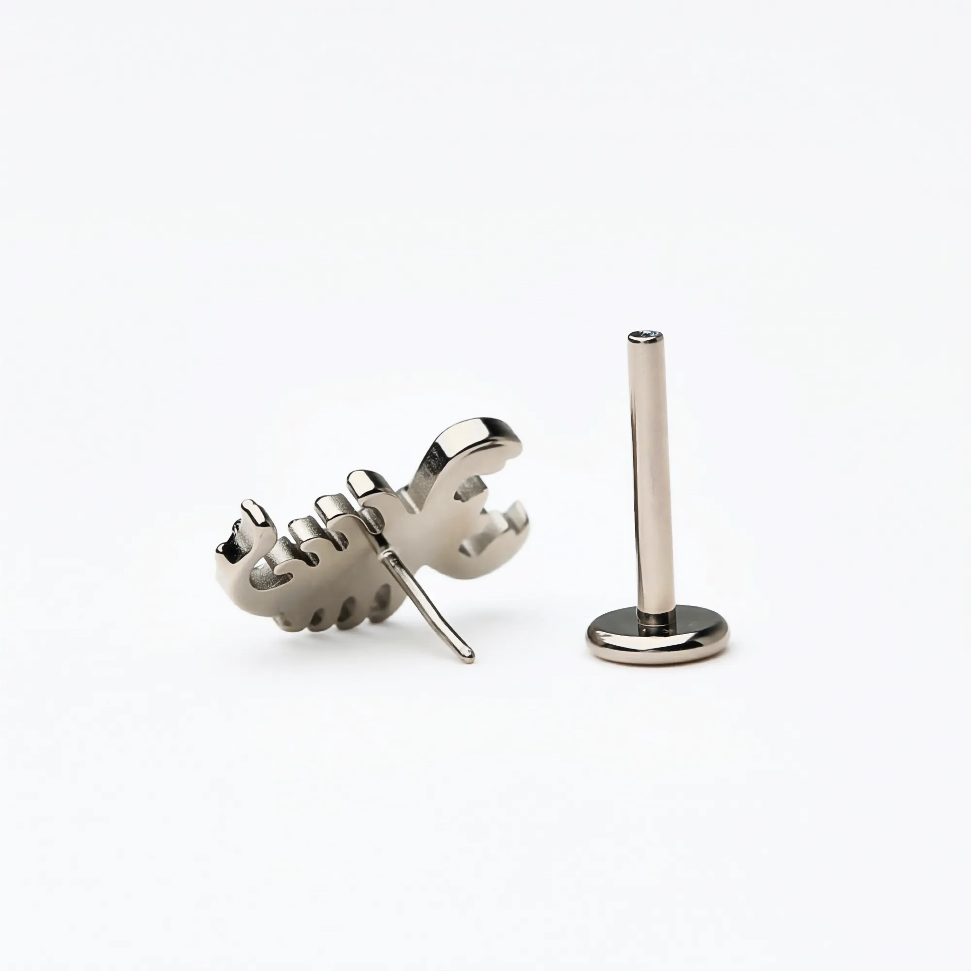 Back and side view of the Titanium Scorpion Curve flat back stud earring in natural titanium. Displays the smooth flat back base and implant-grade titanium push-in post, hypoallergenic and safe for sensitive ears.