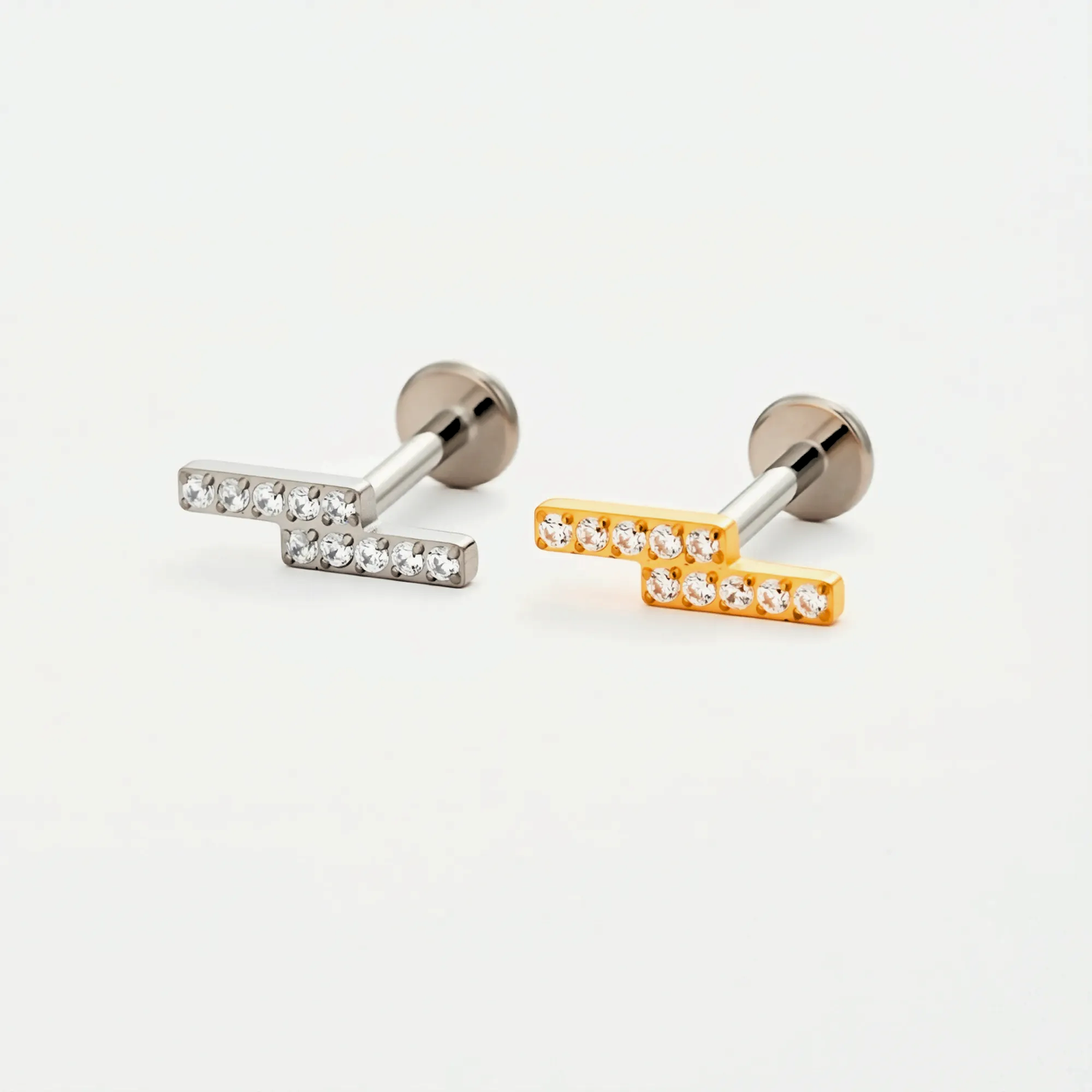 Titanium Twin Bar internally threaded flat back stud earrings in natural titanium and gold, featuring a minimalist double-bar design. Hypoallergenic implant-grade titanium studs on a white background.