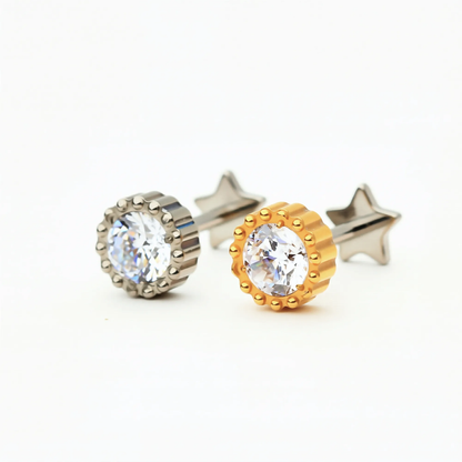 Titanium Crown Spark internally threaded flat back stud earrings in natural titanium and gold, featuring a round crystal center with a crown-style setting. Front view of hypoallergenic implant-grade titanium studs.