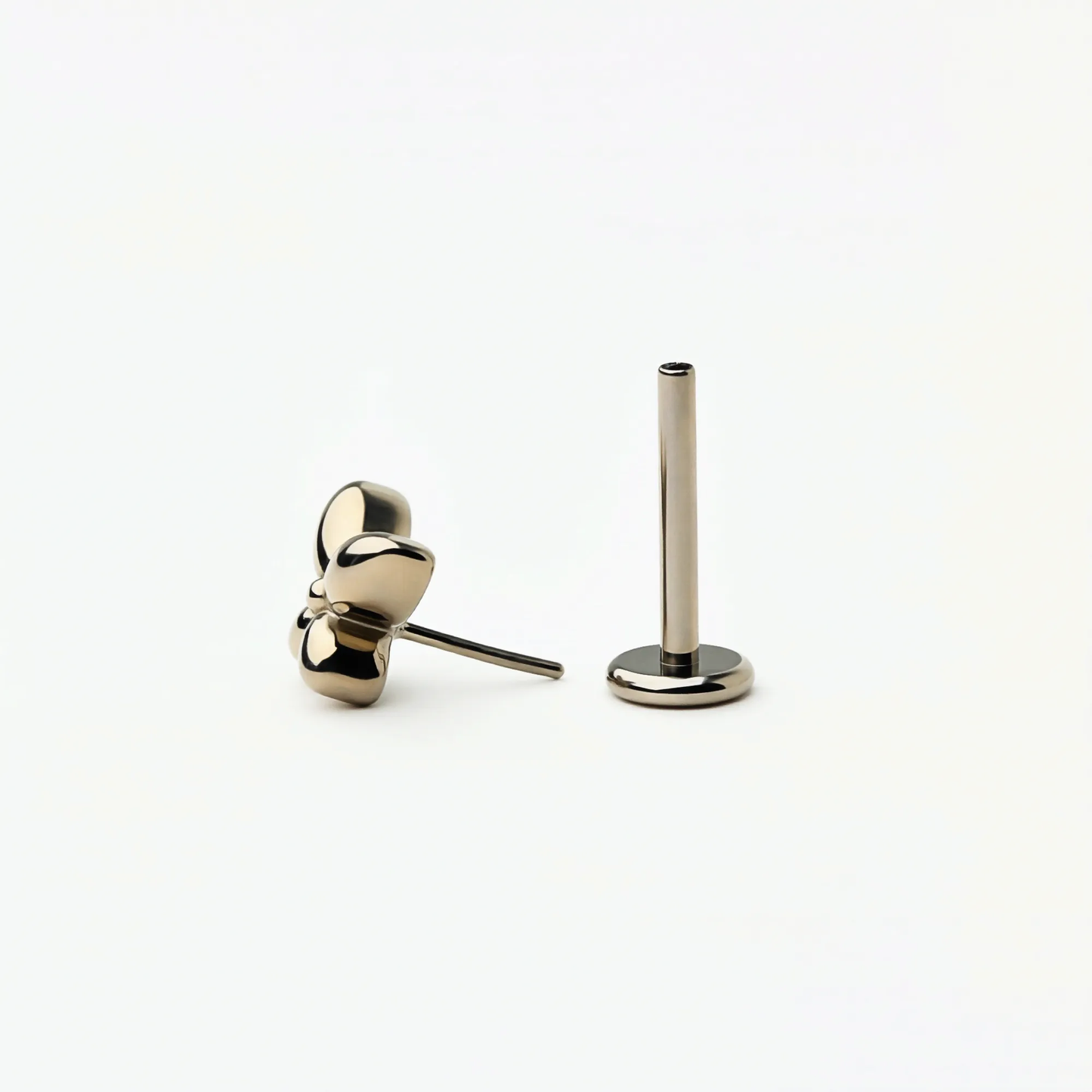 Angled front view of Titanium Petite Butterfly flat back stud earrings in natural titanium. Highlights the butterfly shape and hypoallergenic implant-grade titanium push-in posts.