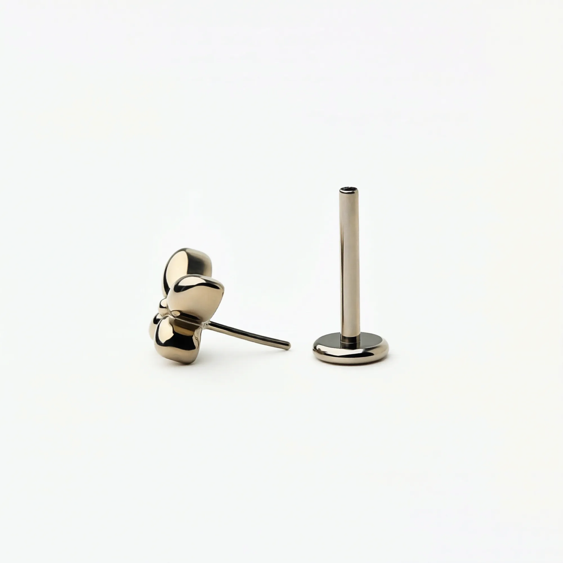 Angled front view of Titanium Petite Butterfly flat back stud earrings in natural titanium. Highlights the butterfly shape and hypoallergenic implant-grade titanium push-in posts.
