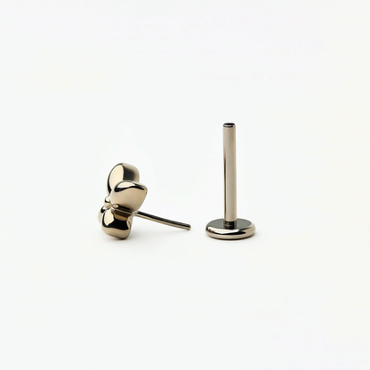Angled front view of Titanium Petite Butterfly flat back stud earrings in natural titanium. Highlights the butterfly shape and hypoallergenic implant-grade titanium push-in posts.