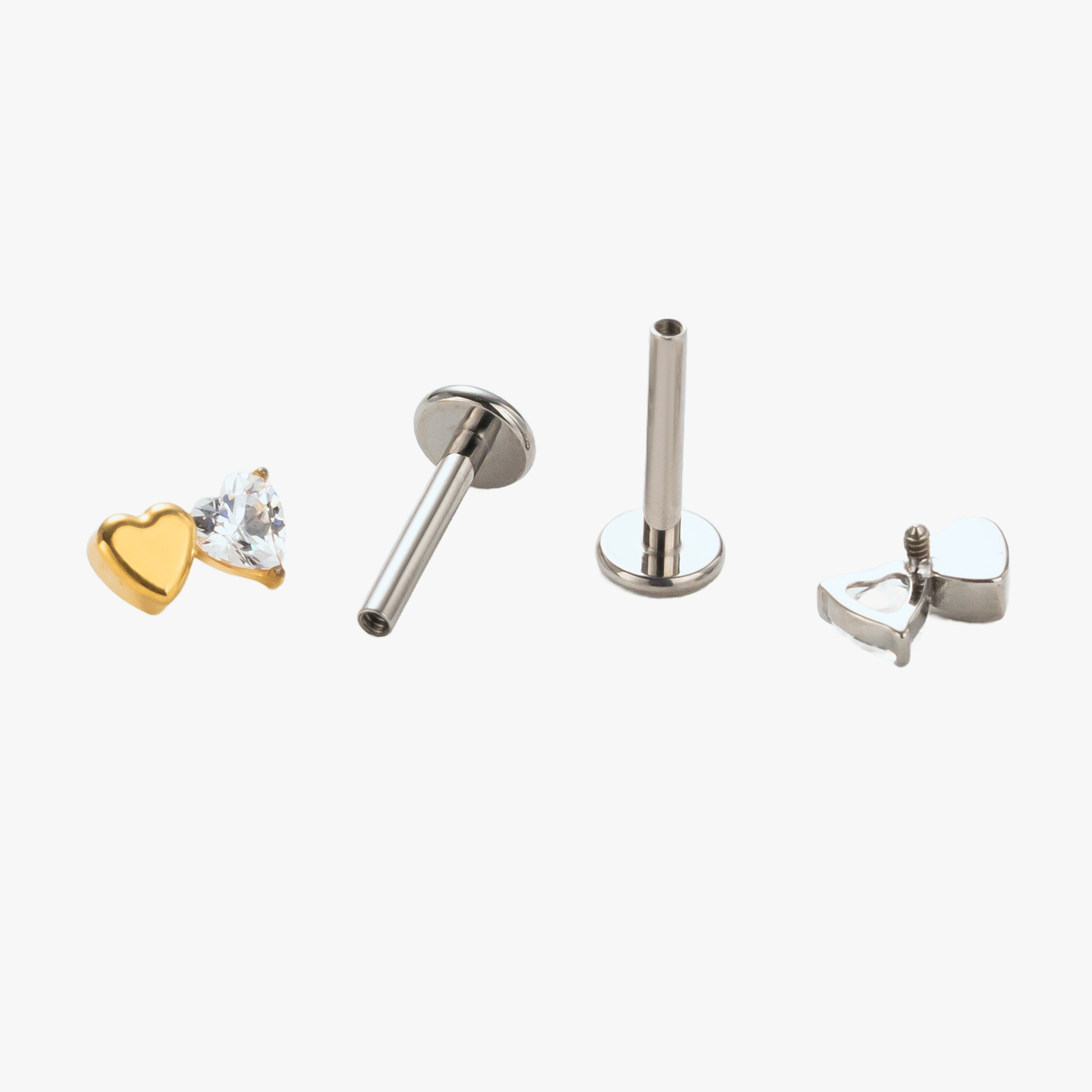 Disassembled view of the Titanium Duo Heart internally threaded flat back stud earring, showing the gold and natural titanium heart-shaped tops, implant-grade titanium post, visible internal threading, and smooth flat back base.