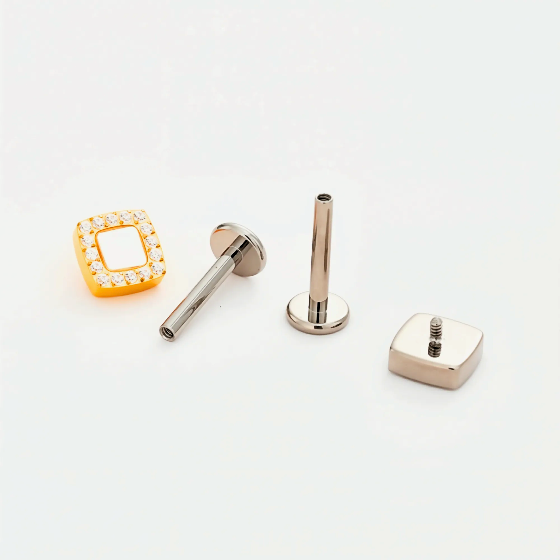 Disassembled view of the Lumi Square titanium internally threaded flat back stud earring, including the square crystal top, implant-grade titanium post with internal threading, and smooth flat back base.