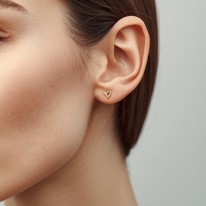 Curved Heart gold-plated titanium earring with opal and cubic zirconia worn on the earlobe