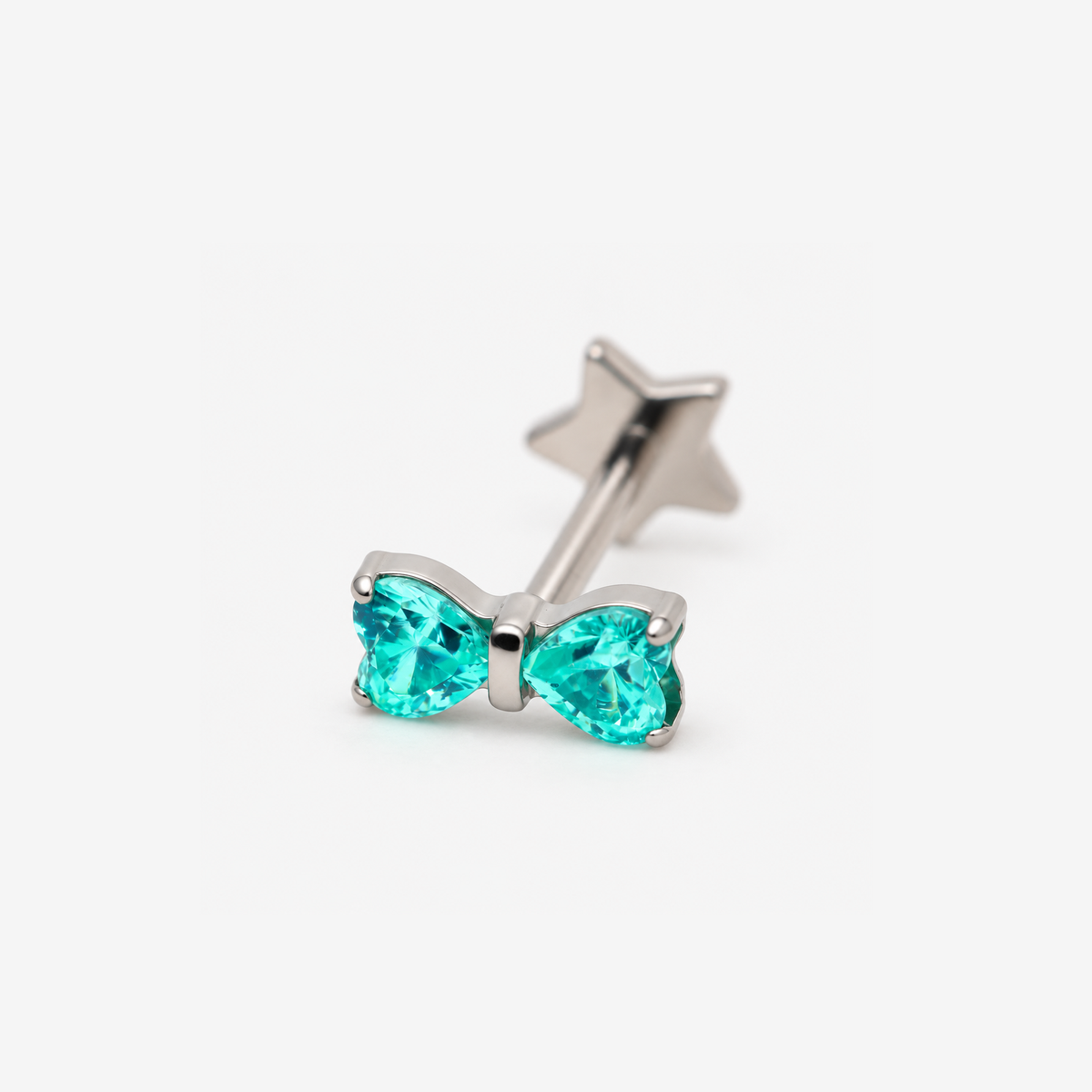Heart Bow titanium flat back earring with teal heart-shaped cubic zirconia stones, front angled view
