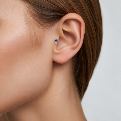 Moonlit blue and clear CZ titanium earring worn on the tragus