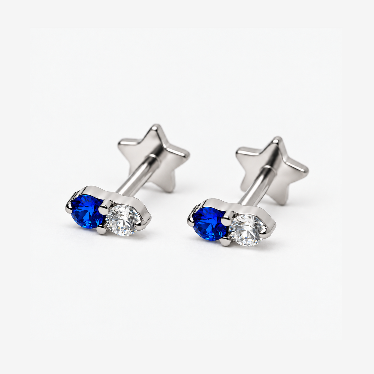 Two Moonlit titanium flat back earrings with blue and clear CZ stones
