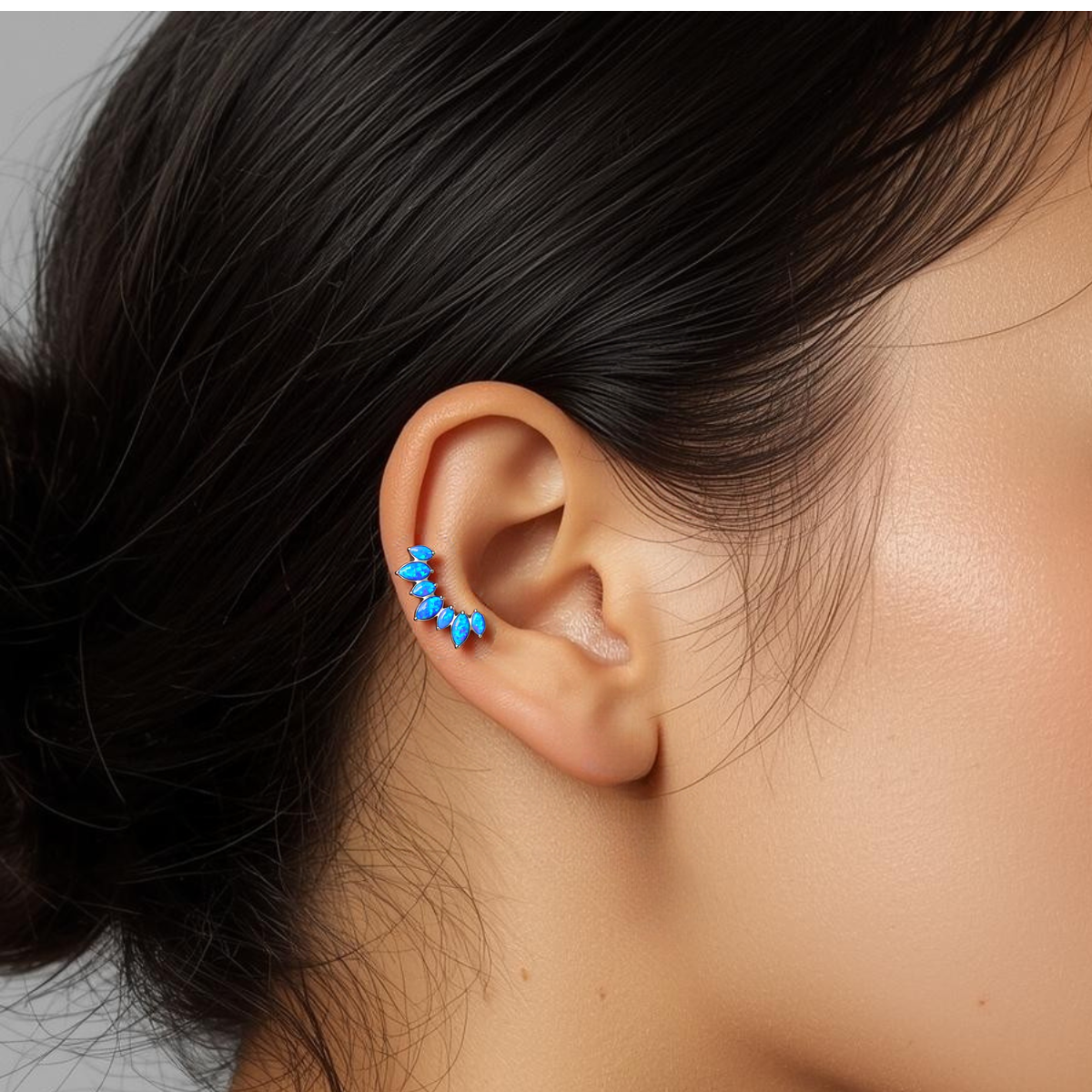 Opal Crown blue opal titanium earring worn along the outer ear cartilage