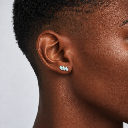 Opal Steps titanium earring with three rectangular opals, worn on the earlobe