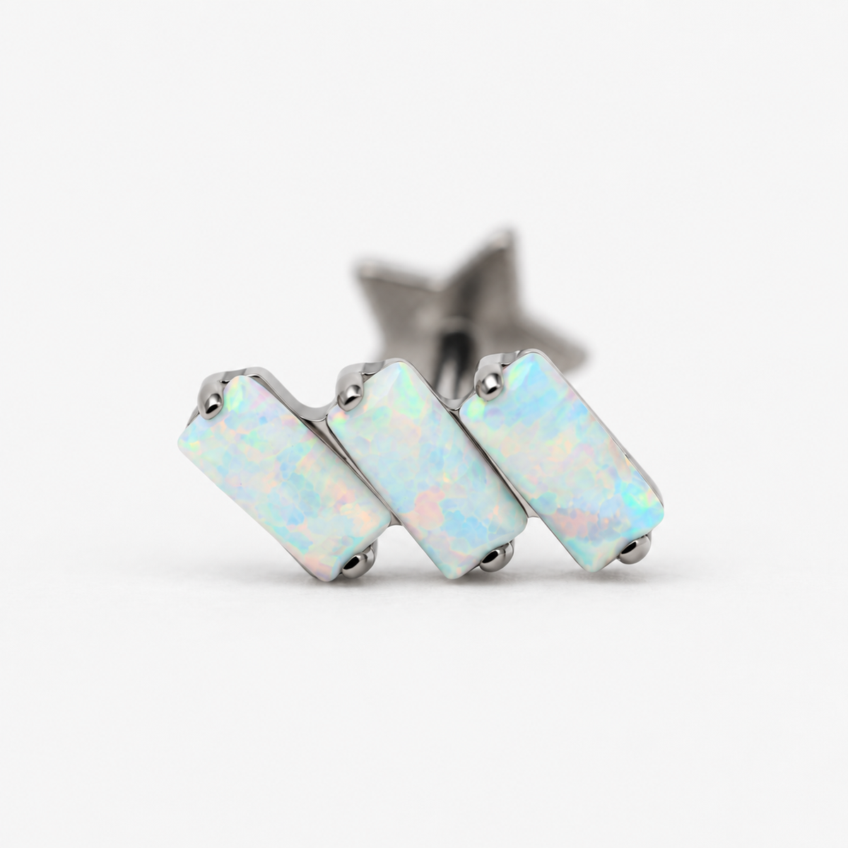 Close-up of the three rectangular opals and polished titanium settings on Opal Steps