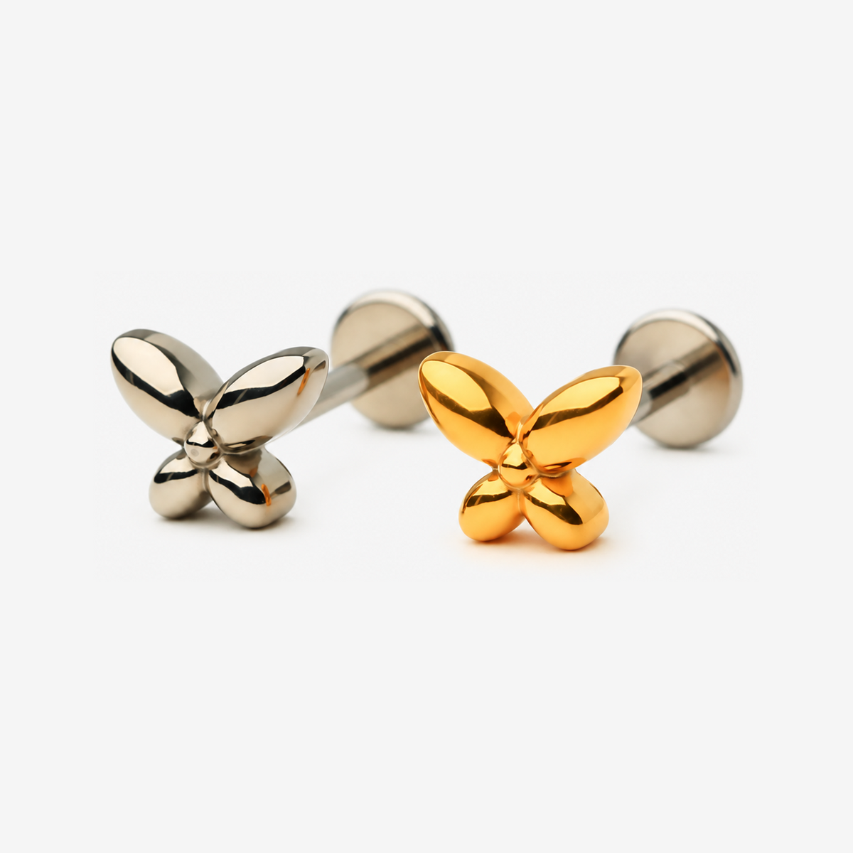 Petite Butterfly flat back stud earrings in titanium and gold.