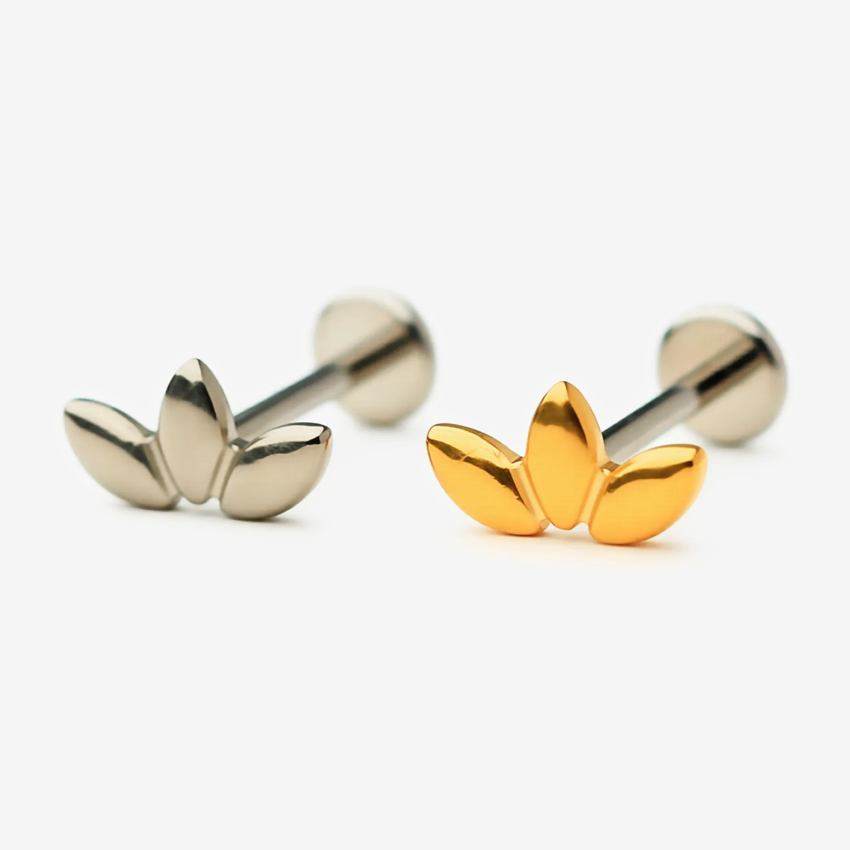 Triple Leaf flat back stud earrings in titanium and gold.