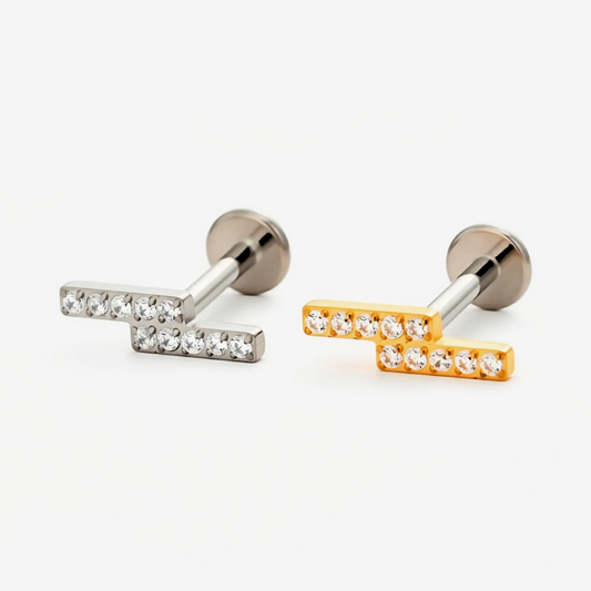 Twin Bar flat back stud earrings in titanium and gold.