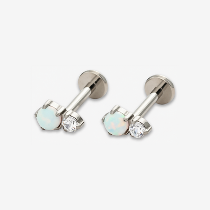 Twin Moonlight titanium flat back earrings with a white opal and clear stone.