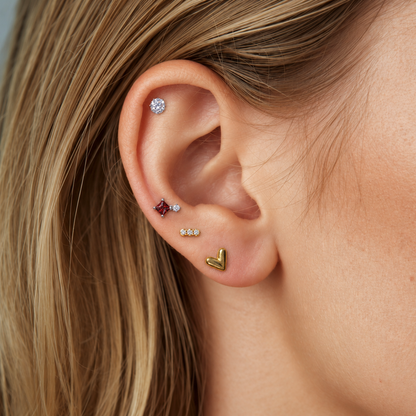 Candy Heart, Mini Trio, Candy Pop and Timeless Radiance titanium flat back earrings worn as an ear stack