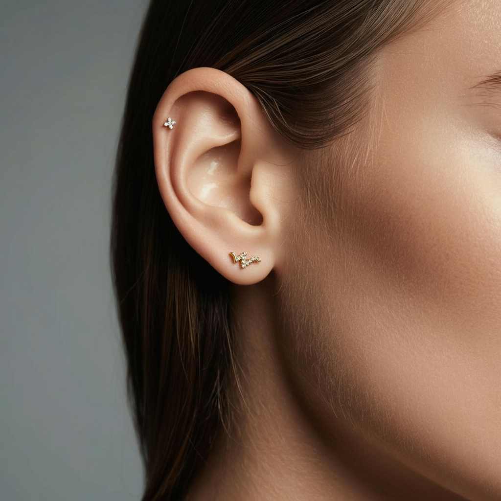 Close-up of model wearing the gold Titanium Snaked Wave internally threaded flat back stud earring, highlighting the crystal zig-zag wave design and flat back comfort.